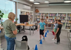 Ikšķiles pilsētas bibliotēkā realizēts neparasts projekts – ar kanisterapijas palīdzību veicināts bērnu lasītprieks. Bērni iesaistās spēlē ar suni