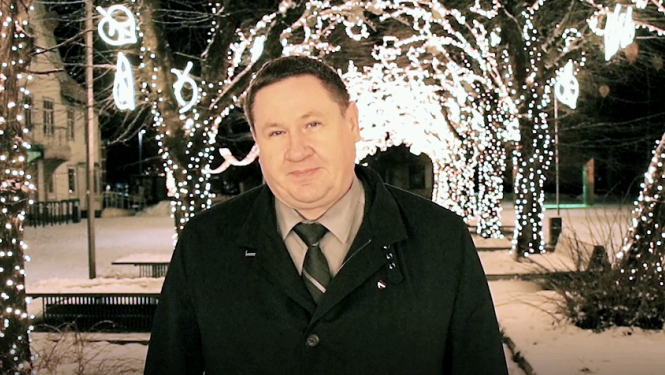 Egils Helmanis uz Ziemassvētku rotājumu fona