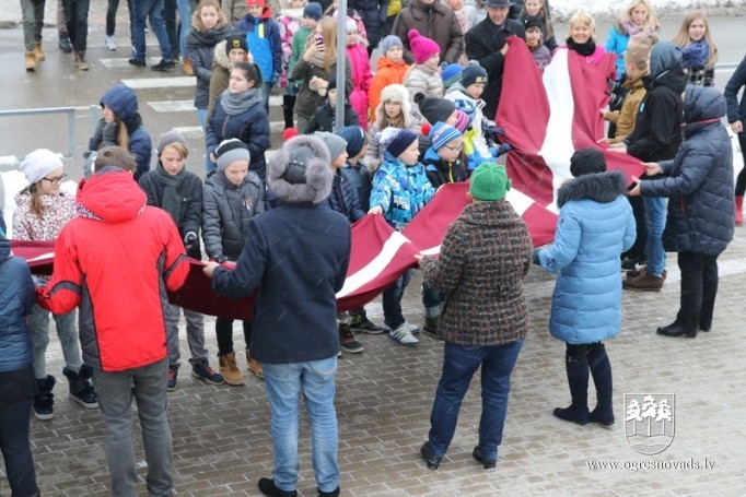 Skolēni godina Latvijas karogu