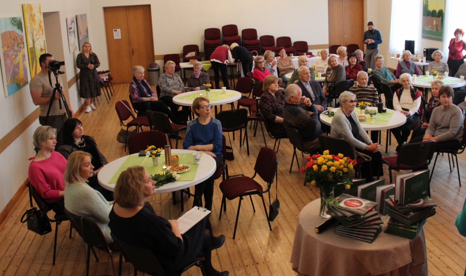 Ikšķiles Senioru pavāgrāmatas atklāšanas pasākums 08.11.2023. Seniori sēž pie galdiem