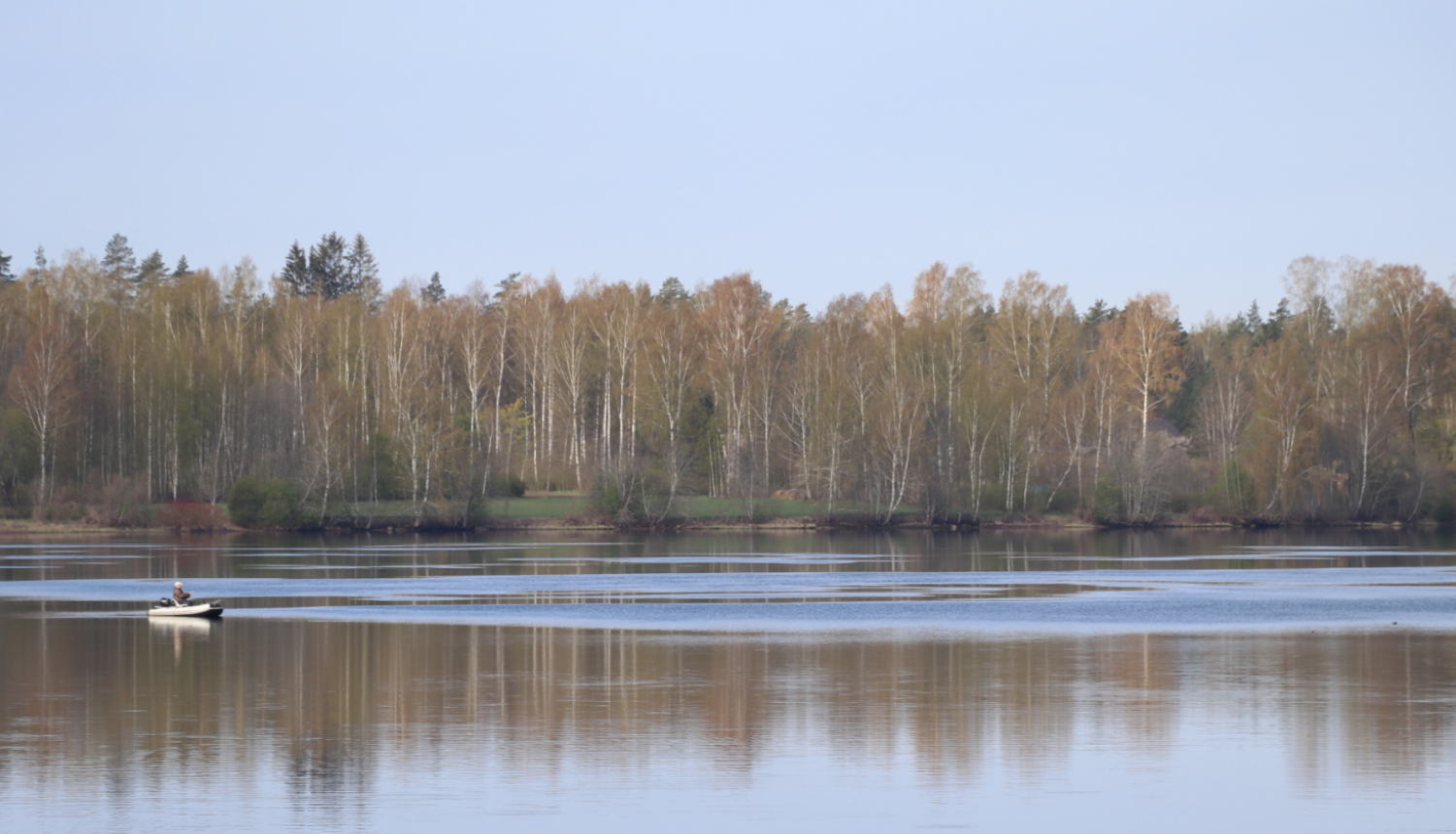 Pavasara skats pāri Daugavai ar bērziem otrā krastā un laivu uz upes
