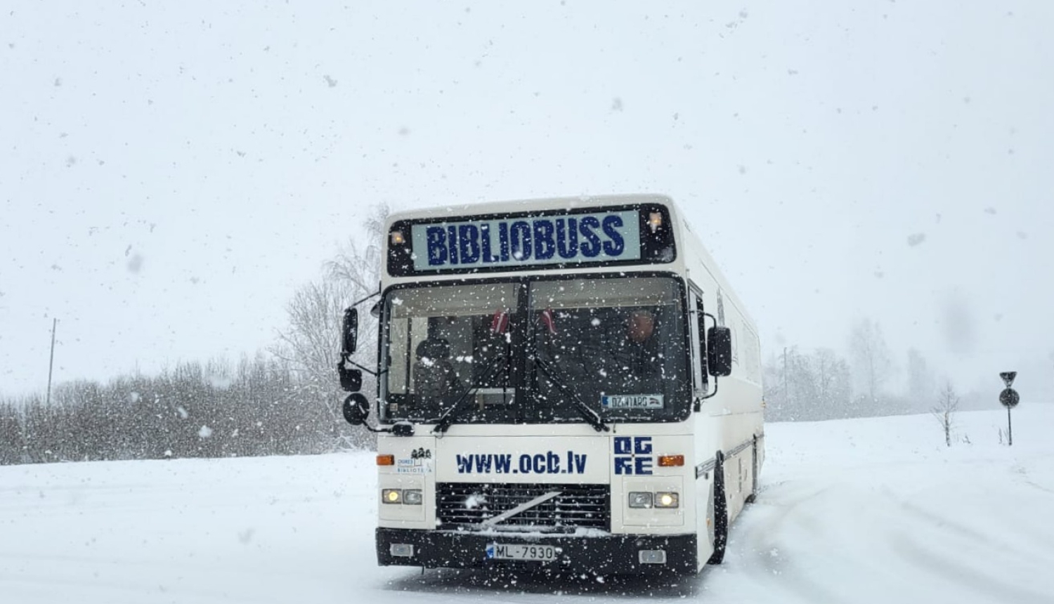 Ogres Centrālās bibliotēkas bibliobuss priekšpuse baltā krāsā, fonā ziema
